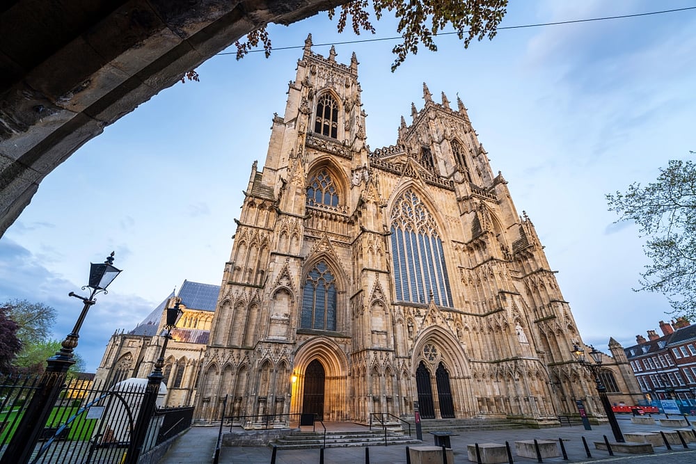 York Minster entrance and towers illuminated at dusk